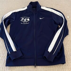 Nike men’s track jacket. Navy blue with white details.  Zippered pockets. Medium